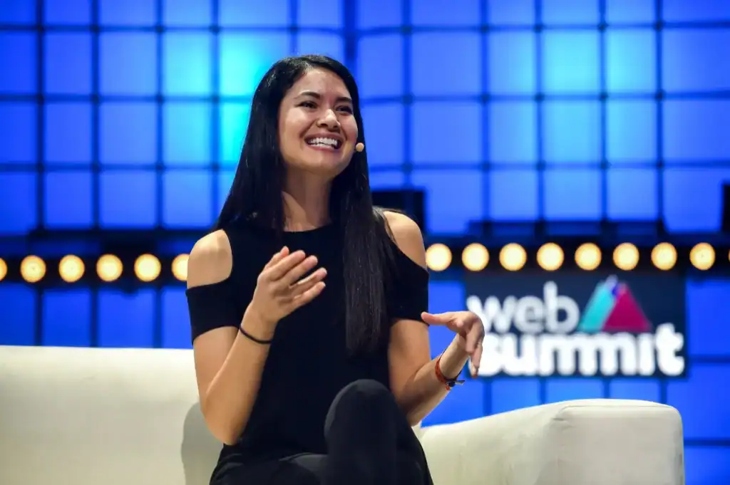 Melanie Perkins appears to be discussing something on the stage.